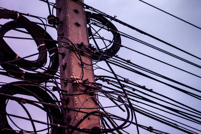 Low angle view of electricity pylon against sky