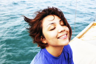 Close-up portrait of young woman on boat