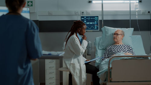 Midsection of doctor examining x-ray in hospital