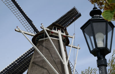 Low angle view of traditional windmill against clear sky