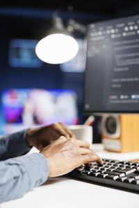 Cropped hand using laptop