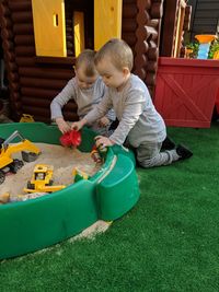 Twin brothers playing with toys