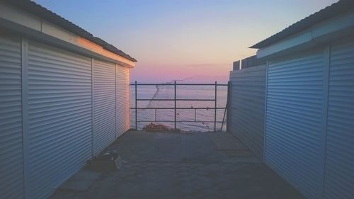 Built structures against sky at sunset