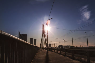 Bridge over road against sky during sunset