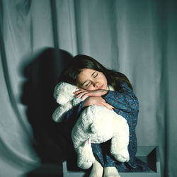 Portrait of cute girl sleeping on bed at home