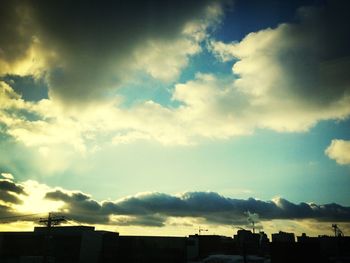 Buildings against cloudy sky