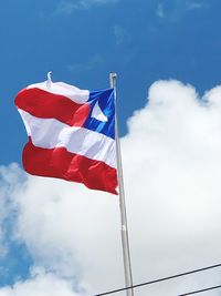 Low angle view of flag of bahia waving against sky