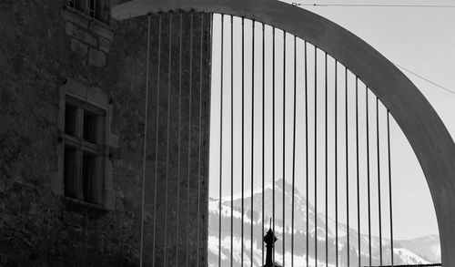 Low angle view of bridge and buildings against sky