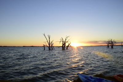 Scenic view of sea against clear sky during sunset