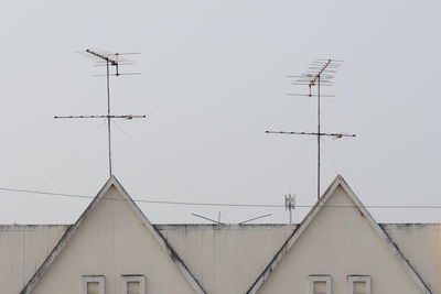 Antennas on building against clear sky