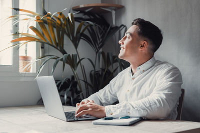 Young man using laptop at office