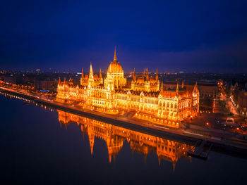 Reflection of illuminated buildings in city at night