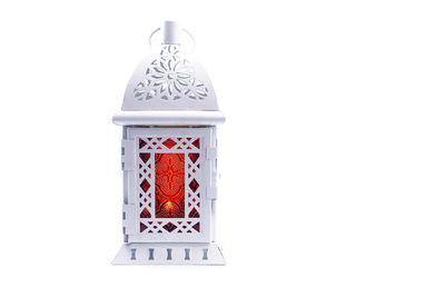 Close-up of lantern over white background