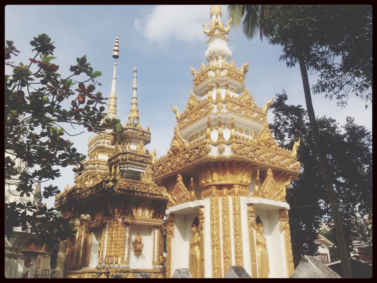 low angle view, architecture, transfer print, religion, place of worship, building exterior, built structure, spirituality, sky, tree, auto post production filter, church, famous place, cathedral, temple - building, travel destinations, cloud - sky, outdoors