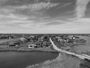 High angle view of river amidst buildings against sky