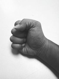 Close-up of hands against white background
