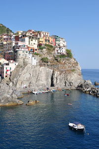 Boats in sea with town in background