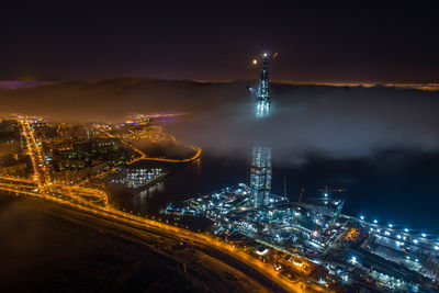 High angle view of illuminated buildings against sky at night