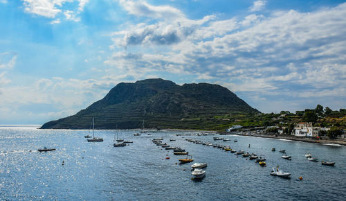 Boats moored in sea against sky