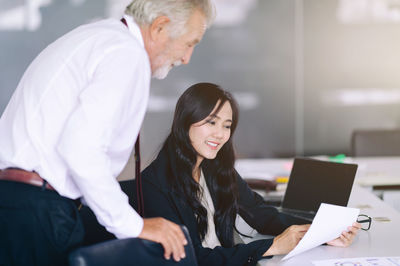 Two people working in office