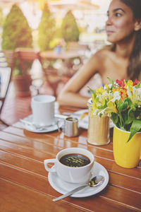 Couple sharing in a cafeteria at sunset, romantic moment with flowers, coffee and vintage site