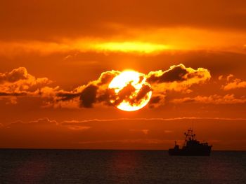 Scenic view of sea against orange sky