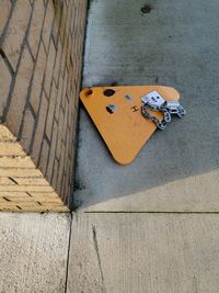 High angle view of toy on footpath by street