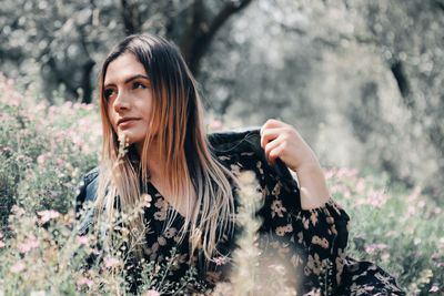 Portrait of woman against plants