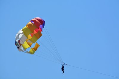 Low angle view of parachute against clear sky