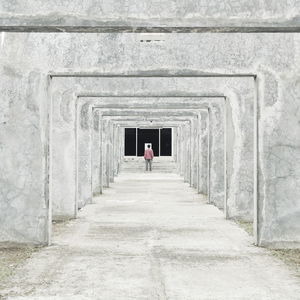 Rear view of man walking on road