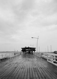 Pier over sea against sky