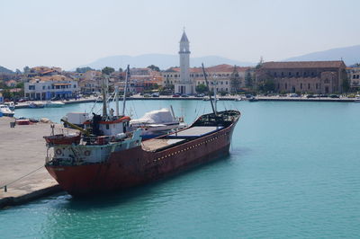 Boats moored on sea against clear sky