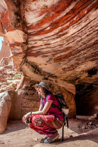 Woman sitting on rock