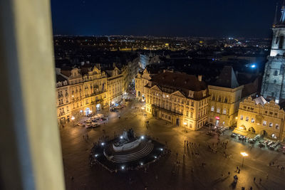 High angle view of illuminated street amidst buildings in city