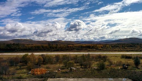 Scenic view of landscape against cloudy sky
