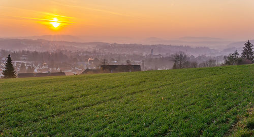 Scenic view of field against sky during sunset