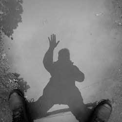 Reflection of man in puddle