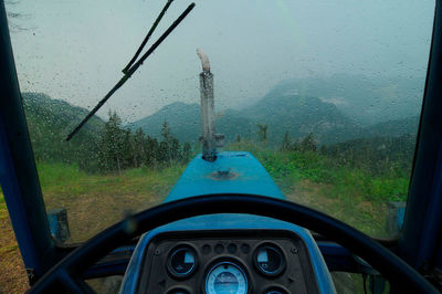 Tractor at timber harvesting in a commercial forest, during a rainy day