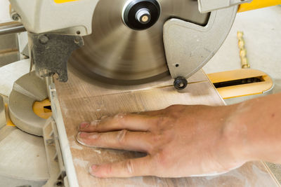 Cropped hand of man working in workshop