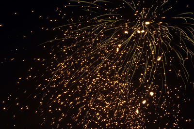 Low angle view of firework display at night
