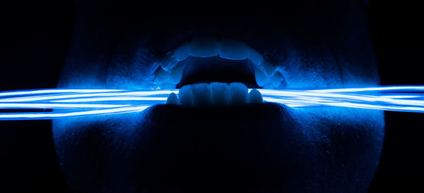 Close-up of illuminated lamp against black background