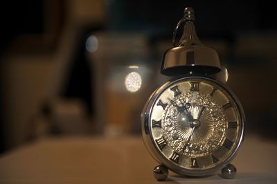 Close-up of alarm clock on table