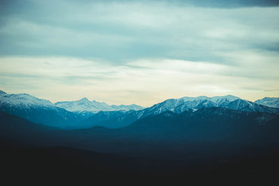 Scenic view of snowcapped mountains against sky