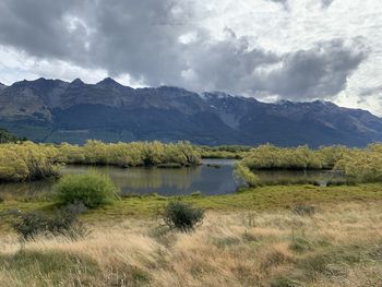 Scenic view of lake and mountains against sky