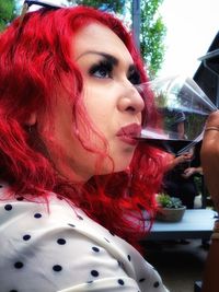 Close-up portrait of a young woman holding drink