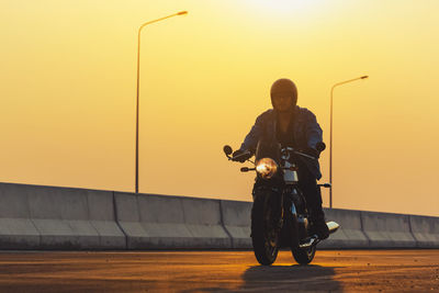 Young man riding big bike motocycle on asphalt high way against, motorbike man has freedom