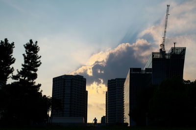 Silhouette buildings against sky during sunset