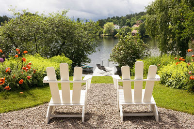 Sun chairs in garden overlooking lake