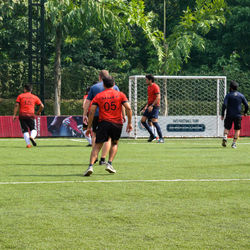 People playing soccer on field