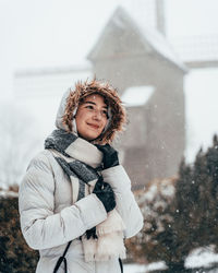 Portrait of woman standing in snow